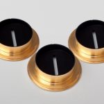3 metallic circular components coated with acktar’s magic black coating